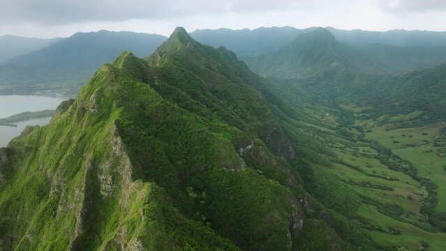 Aerial nature panorama. Cinematic Mountain Range Jurassic park movie destination. Success copy Kualoa Ranch on Oahu island Hawaii. Summer Inspiring Landscape. Scenic green peaks under sunrise clouds