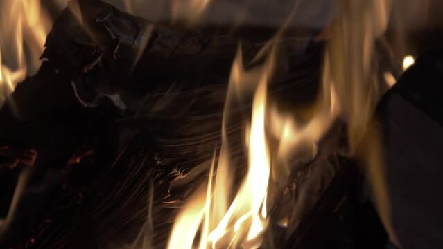 An open book burning in a fire of dry vets at night in an ancient building in oriental style