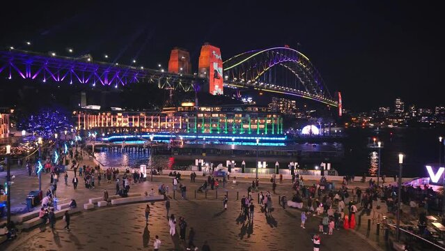 Sydney, Australia -4k Video - Colorful Sydney City skyline by night at Sydney Harbour Bridge during Vivid Sydney Lights Festival -Free annual outdoor event of light, music and ideas in May-June, 2023.
