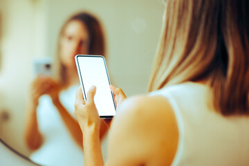 Unrecognizable Person Holding a Blank Phone Display for Mock up. Woman using a touchscreen device o text and browse online