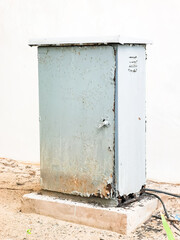 Rusty outdoor weather proof electrical cabinet mounted on a concrete base