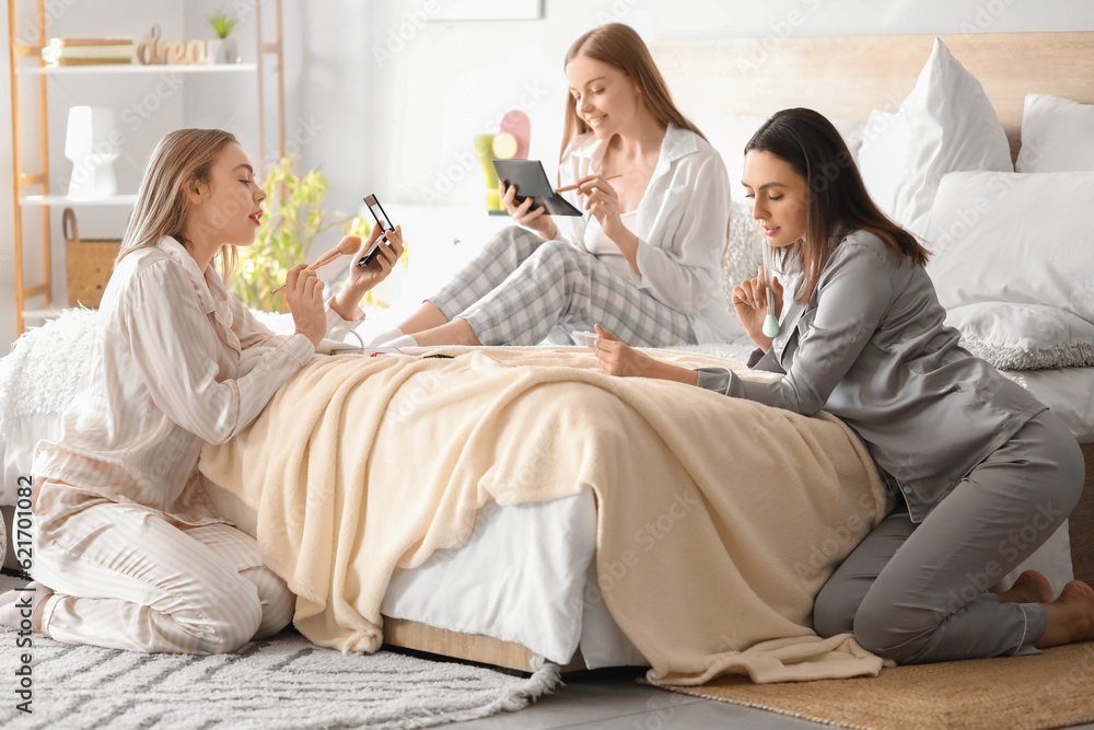 Poster Young women doing makeup in bedroom