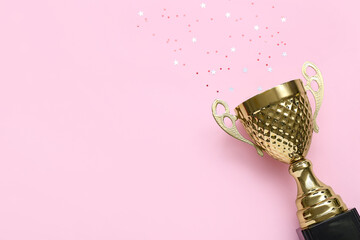 Gold cup with stars on pink background