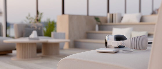 Close-up image of a VR goggles on a comfortable white couch in a beautiful living room