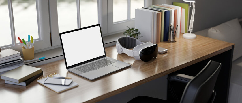 Close-up image of a modern home workspace in bedroom, laptop mockup on a wooden table