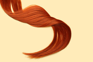 Ginger hair strand on color background, closeup