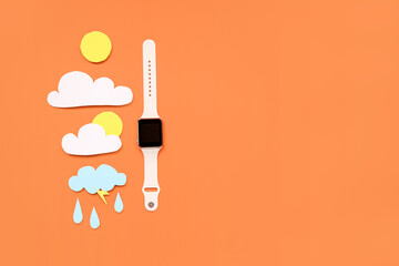Smartwatch with paper clouds, sun and rain drops on red background. Weather forecast concept