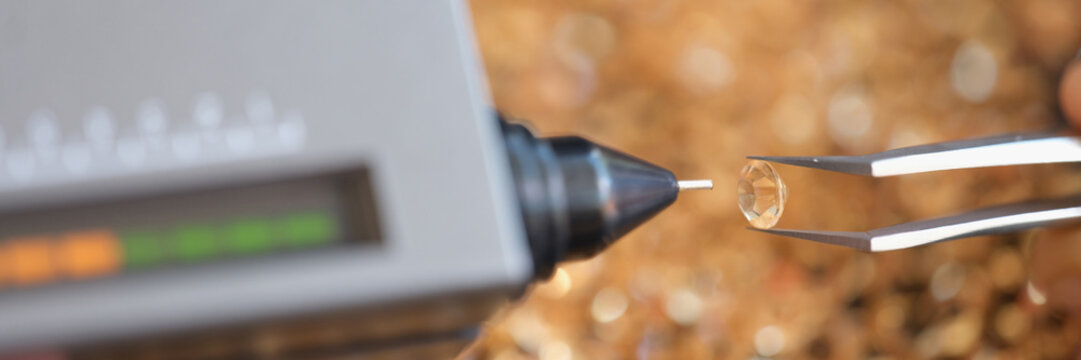 Diamond in tweezers, diamond cut or checking