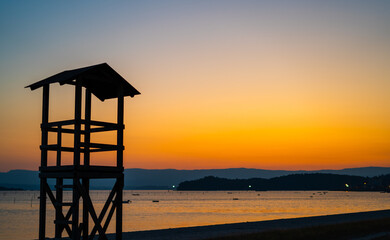 nice sunset summer view with a lifeguard hut and copy space