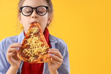 Little girl eating tasty pizza on yellow background, closeup