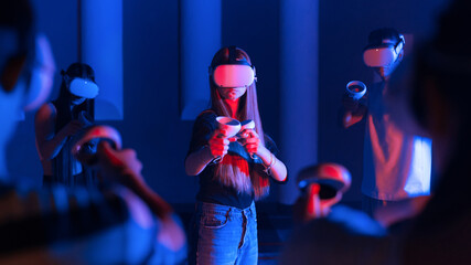 A team of young friends using virtual reality VR equipment on a arena