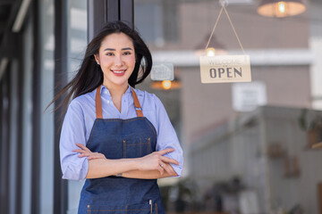 Startup successful small business owner sme beauty girl stand with tablet smartphone in coffee shop restaurant. Portrait of asian tan woman barista cafe owner. SME entrepreneur seller business concept