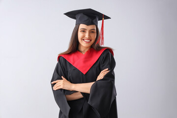 Female graduate student on light background