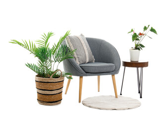 Grey armchair with table, houseplants and rug on white background