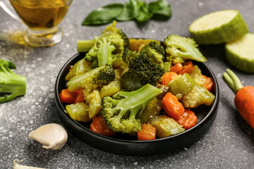 Plate with different fried vegetables on grunge background
