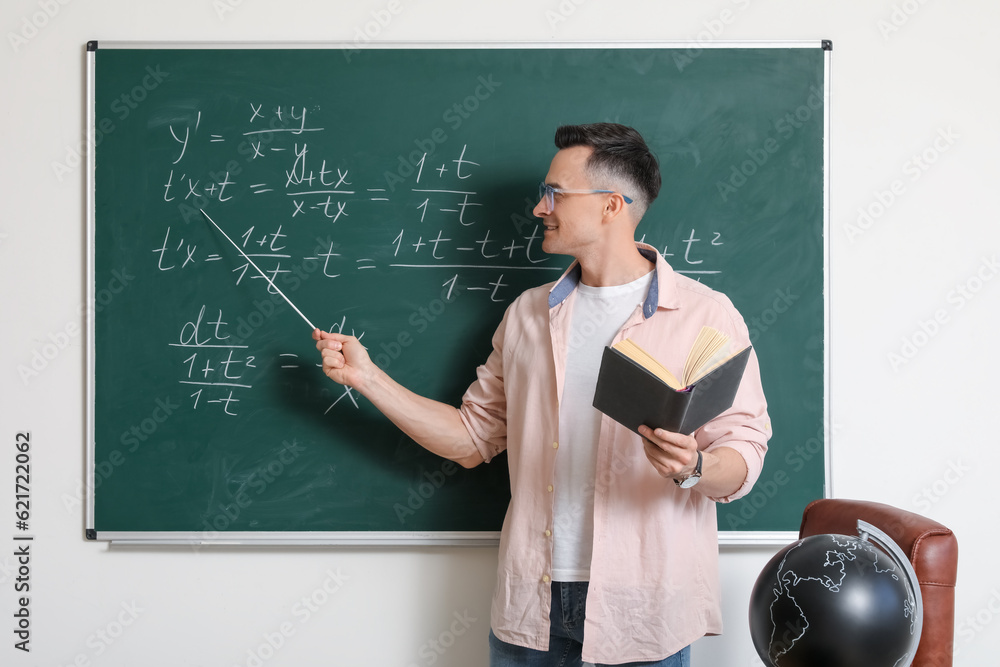 Sticker male math teacher conducting lesson near chalkboard in classroom