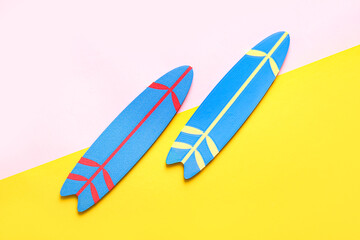 Mini surfboards on color background