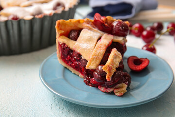 Plate with piece of tasty cherry pie on blue background
