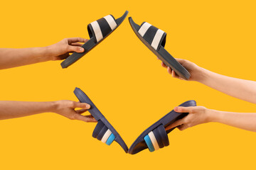 Hands with flip-flops on yellow background