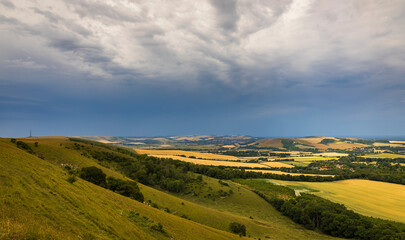 July  storm clouds over Firle Beacon on the south downs east Sussex south east England