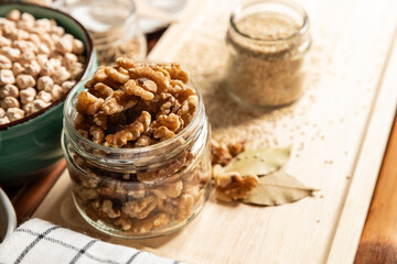 small jar with mixed nuts on rustic table top view. Healthy food and snack.