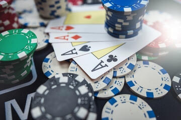 The winning combination is four aces cards and chips on casino table