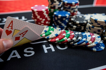player is holding two ace cards - win combination at poker