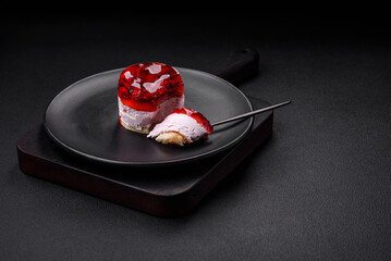 Delicious fresh sweet cheesecake cake with berries and red color jelly