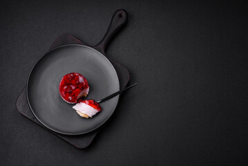 Delicious fresh sweet cheesecake cake with berries and red color jelly