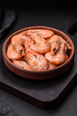 Delicious fresh boiled tiger prawns with salt and spices on a ceramic plate
