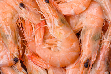 Delicious fresh boiled tiger prawns with salt and spices on a ceramic plate