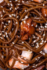 Delicious fresh buckwheat noodles with boiled tiger prawns, salt, spices and mushrooms