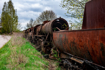 Old rusted steam locomotive abandoned at train cemetery