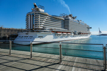 Big modern MSC Cruises cruiseship or cruise ship liner Seaside Seaview in port with downtown Genova...