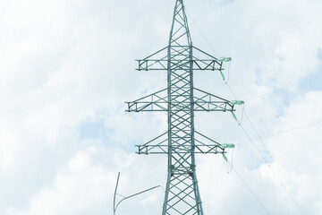 High voltage towers with sky background. Power line support with wires for electricity transmission. High voltage grid tower with wire cable at distribution station. Energy industry, energy saving