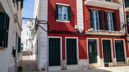 Alaior, Menorca , cultural center of the island. street view and architecture. white houses an church