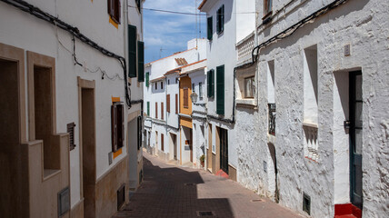 Alaior, Menorca , cultural center of the island. street view and architecture. white houses an church
