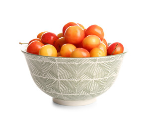 Bowl with sweet yellow cherries on white background