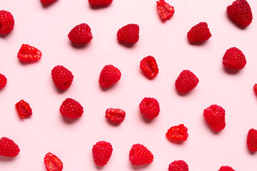Many fresh raspberries on pink background