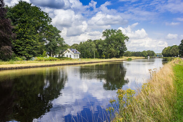 Fototapeta premium Little white house at the Noord-Willems canal in Drenthe, Netherlands