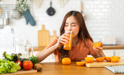 Portrait of beauty body slim healthy asian woman drinking glass of juice and orange.young girl...