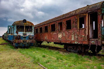 Fototapeta na wymiar Abandoned old rusty electric multiple unit and passenger car