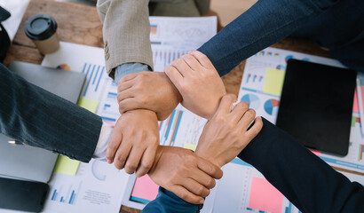 Close up business people holding each others wrists, join hands together, support and unity, team...