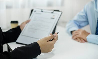 HR Manager talks to job applicants for job interviews about careers and Her personal history in the...