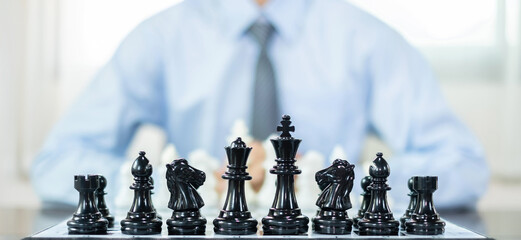 hand of businessmen moving chess in competition shows leadership, followers, and business success...