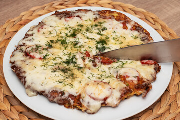 Homemade pizza from zucchini without flour on white plate. Healthy breakfast ideas
