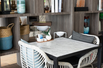 The Photo of a white marble dining table in a restaurant with a vase of flowers on top. interior...