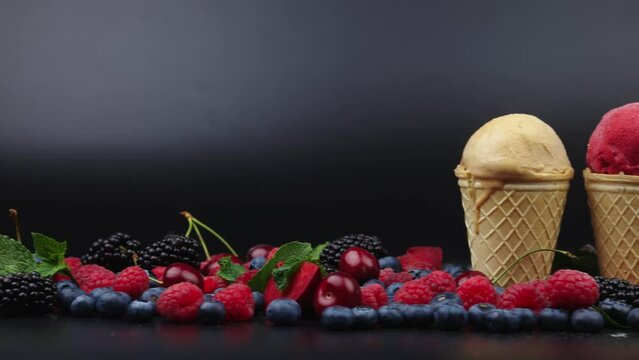 Fresh berries and fruits with creamy ice cream in assorted flavors with raspberry, berry, blueberry, strawberry, pistachio, chocolate, sugar cones