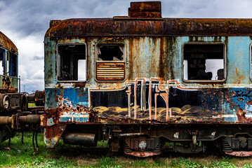 Old rusty electric multiple units abandoned on unused railway tracks