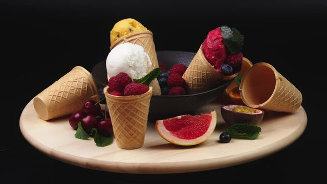 Fresh berries and fruits with creamy ice cream in assorted flavors with raspberry, berry, blueberry, strawberry, pistachio, chocolate, sugar cones